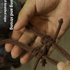 A hand is holding a piece of dark brown braided rope, demonstrating its strength.