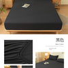 A black soft brushed fitted sheet displayed on a bed, showing close-ups of the fabric texture and elastic edge.