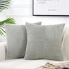A set of two gray corduroy patchwork throw pillow covers with vertical ribbed texture.