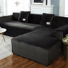 A dark gray plush velvet elastic sofa cover is shown on an L-shaped sectional sofa in a living room setting.