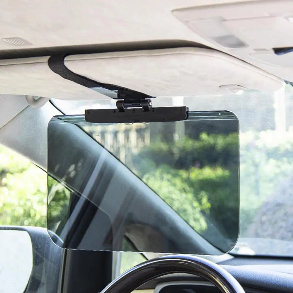 A clear anti-glare car sun visor extender is mounted on the windshield of a vehicle.