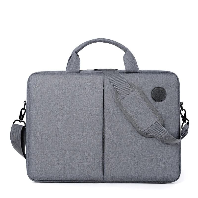 A gray men's business commuter laptop briefcase with a padded shoulder strap and a circular detail.