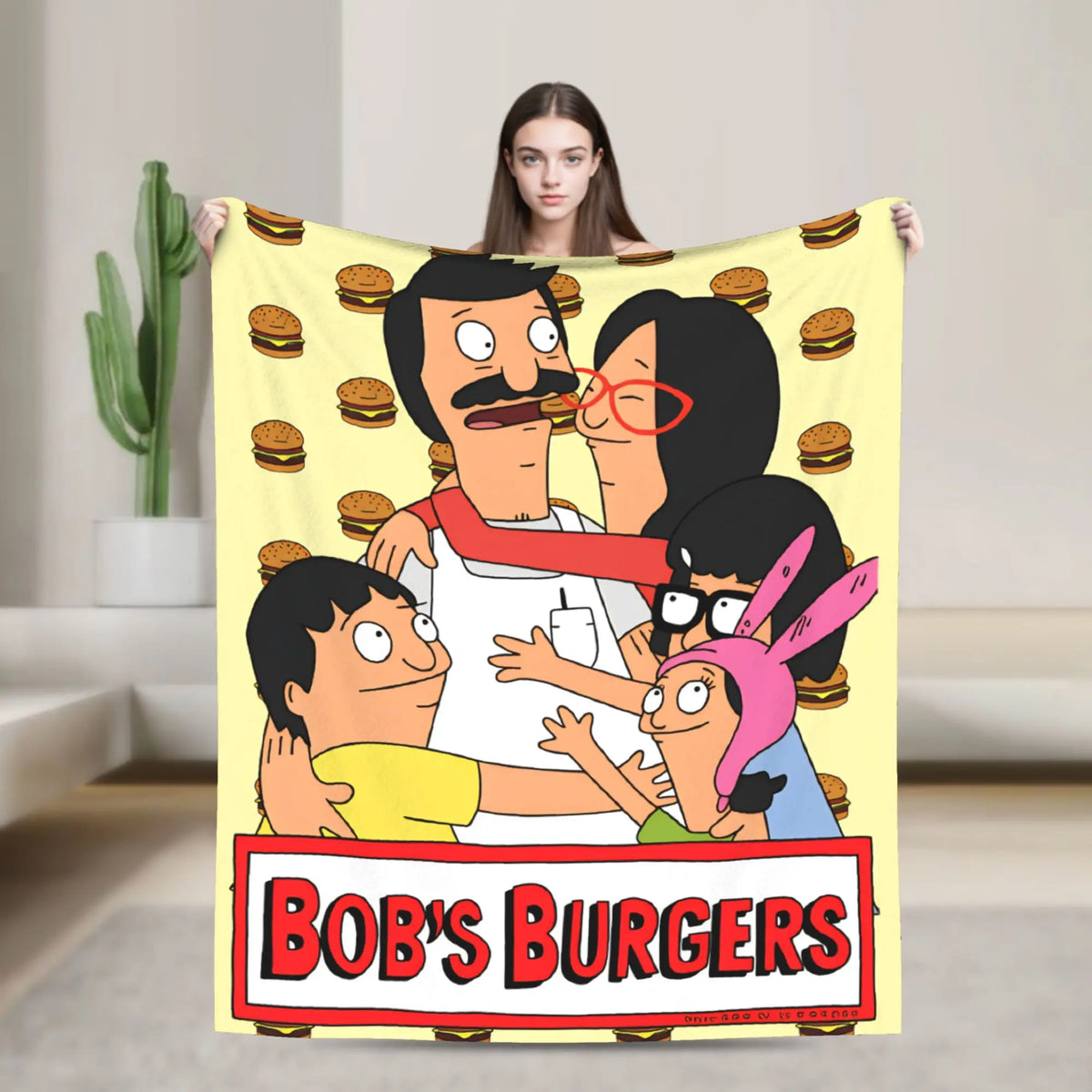 A playful cartoon featuring characters from Bob's Burgers on a yellow blanket.