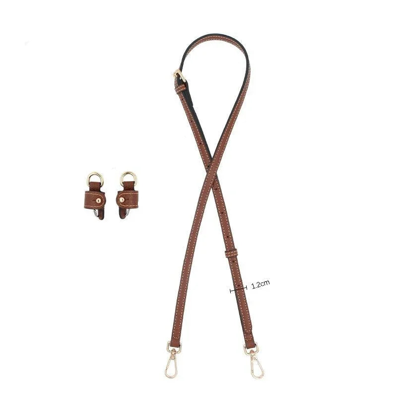 A brown leather shoulder strap with a buckle is shown against a white background.