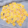 A collection of yellow and cream star-shaped embroidered iron-on patches for DIY clothing decoration.