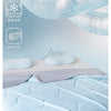 Light blue ice silk cooling blanket folded on a bed with decorative winter snowflake icons.