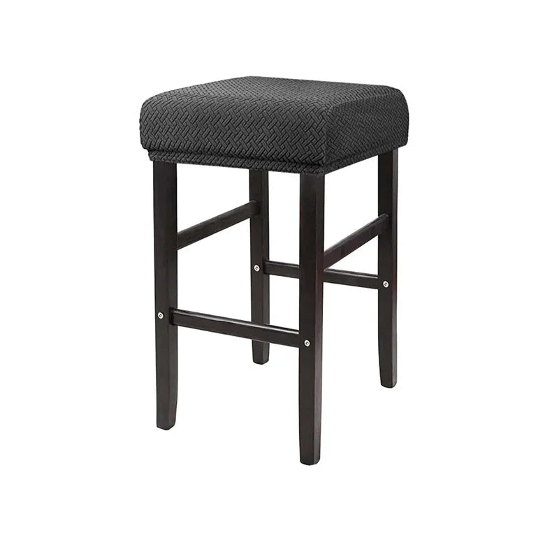 A dark brown bar stool slipcover made of stretchy jacquard fabric with an elastic edge.