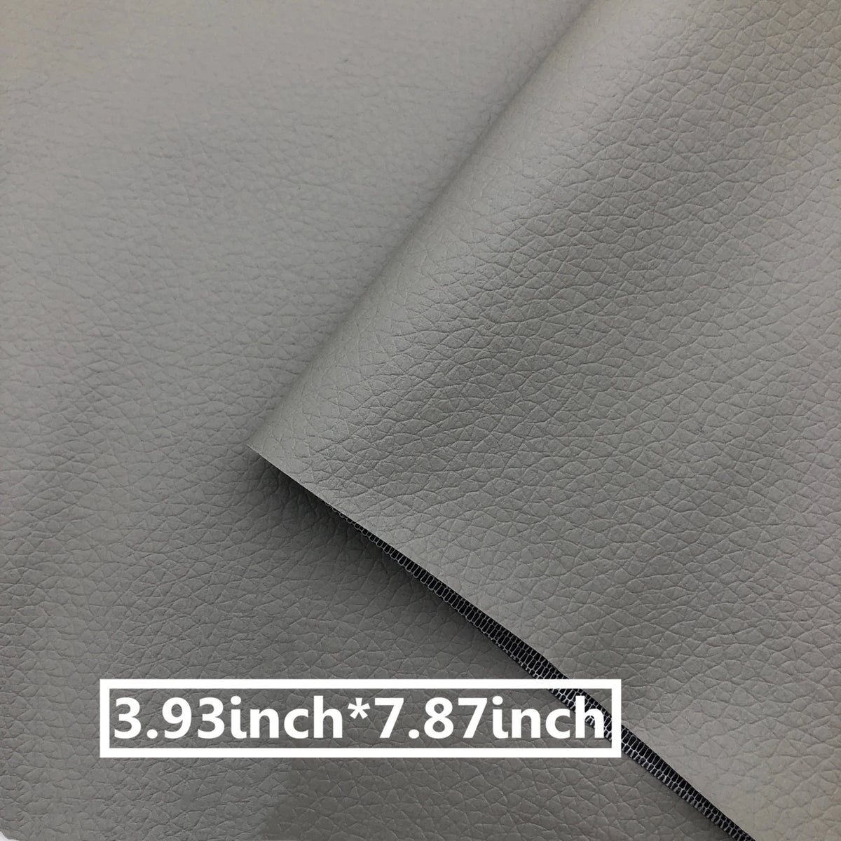 A close-up of a gray leather repair patch, measuring 3.93 inches by 7.87 inches.