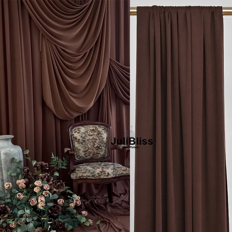 A close-up of a dark brown velvet curtain fabric draped elegantly, used for backdrops and decor.