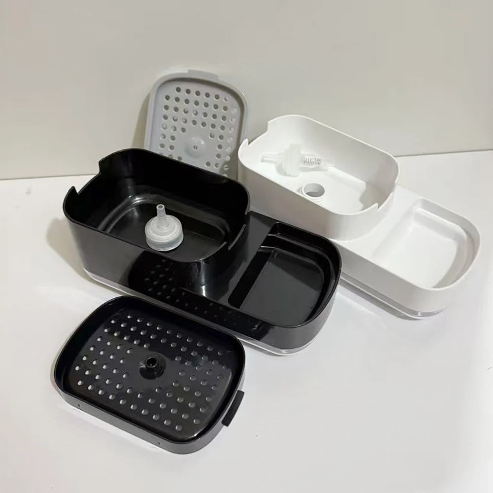 A set of black and white countertop soap dispensers with built-in sponge holders.