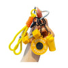 A hand holds a yellow fitness keychain with a carabiner and orange cord.