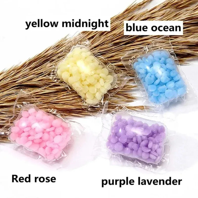 Assortment of yellow midnight, blue ocean, red rose, and purple lavender water-soluble laundry fragrance beads