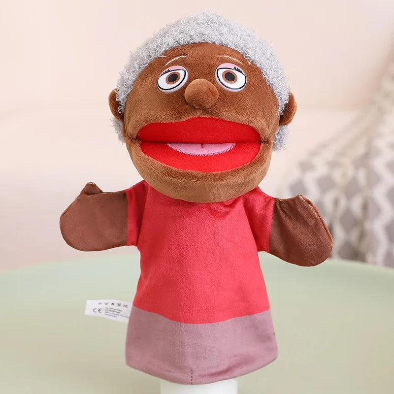 A soft plush hand puppet with brown skin, gray hair, and red clothing, designed for kids' role-play.