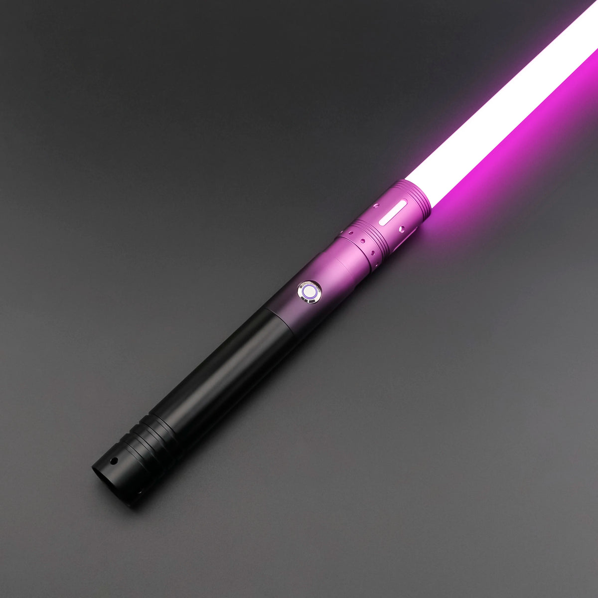 A close-up view of an RGB heavy dueling lightsaber with a purple blade and metal hilt against a dark background.