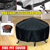 Black all-weather waterproof fire pit cover with a stand, shown in an outdoor setting.
