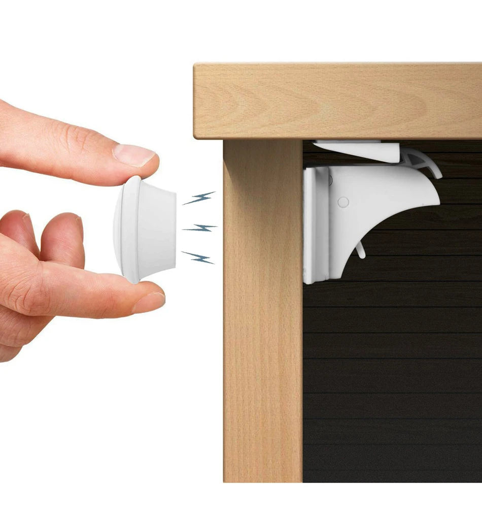 A hand is shown inserting a white magnetic lock into a wooden cabinet door, demonstrating the invisible magnetic cabinet lock