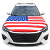 A white car hood covered with a patriotic American flag design featuring red, white, and blue stripes and stars.
