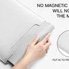 A hand is placing a gray PU leather laptop sleeve into a laptop to protect it from the machine.