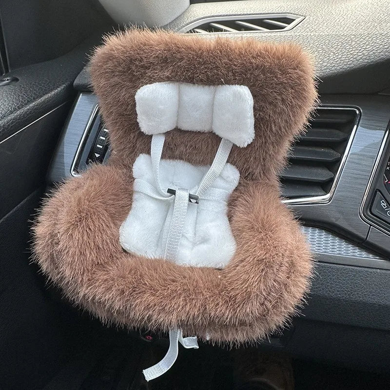 A miniature doll seat car vent decoration covered in fluffy brown faux fur with a white trim and tie.