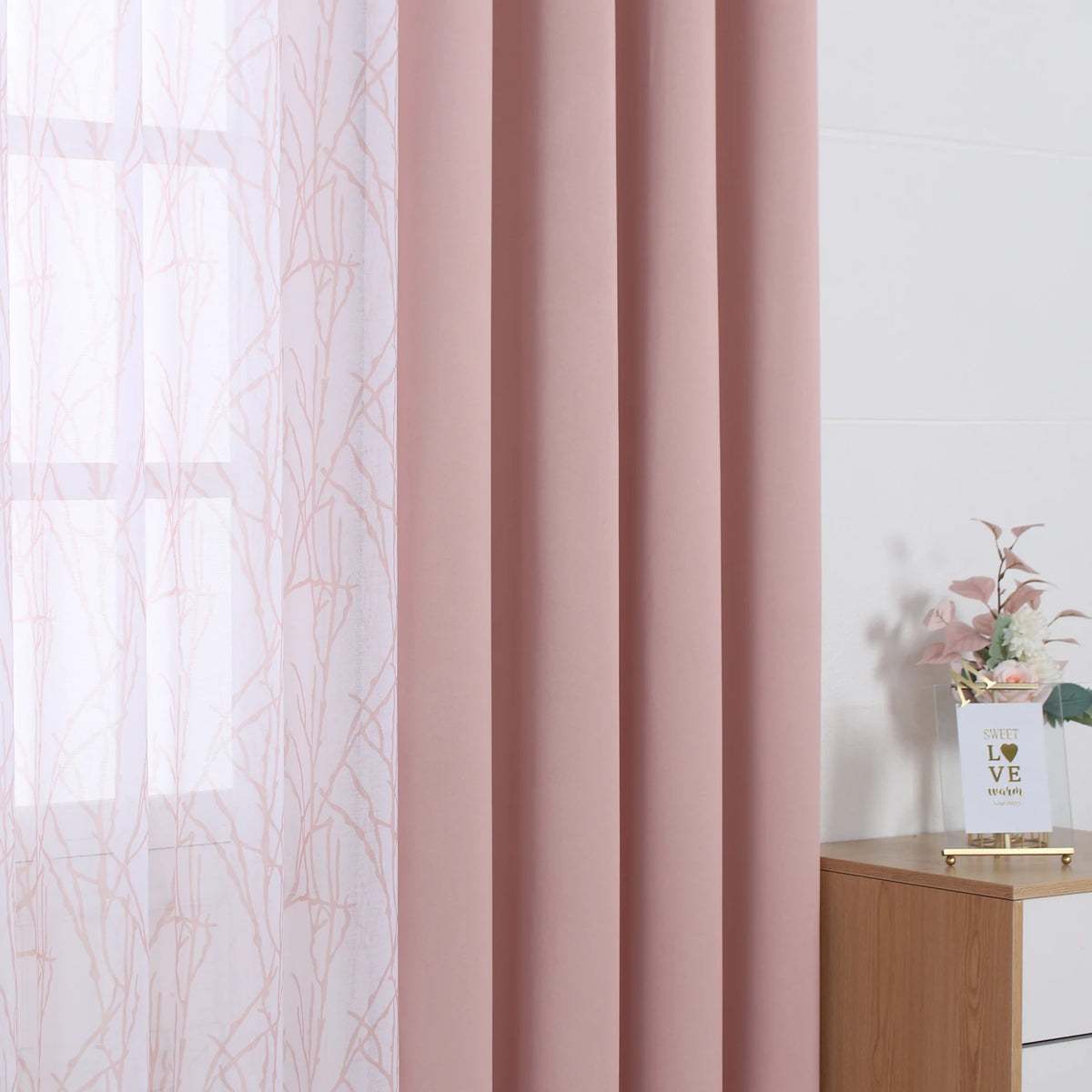 Pink dual layer window curtains featuring sheer and blackout fabric in a soft rose color