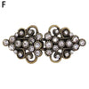 Vintage gold-toned swirl clip featuring clear rhinestones for holding sweaters and cardigans