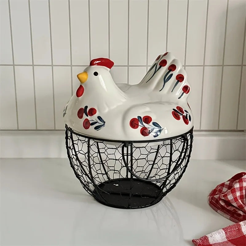 A white ceramic hen-shaped egg basket with a lid and black wire mesh bottom