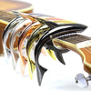 A close-up of a pro-grade zinc alloy guitar capo with various colored and shaped metal pieces.