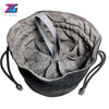 A gray velvet dice storage pouch with a drawstring and black cord is shown from above.