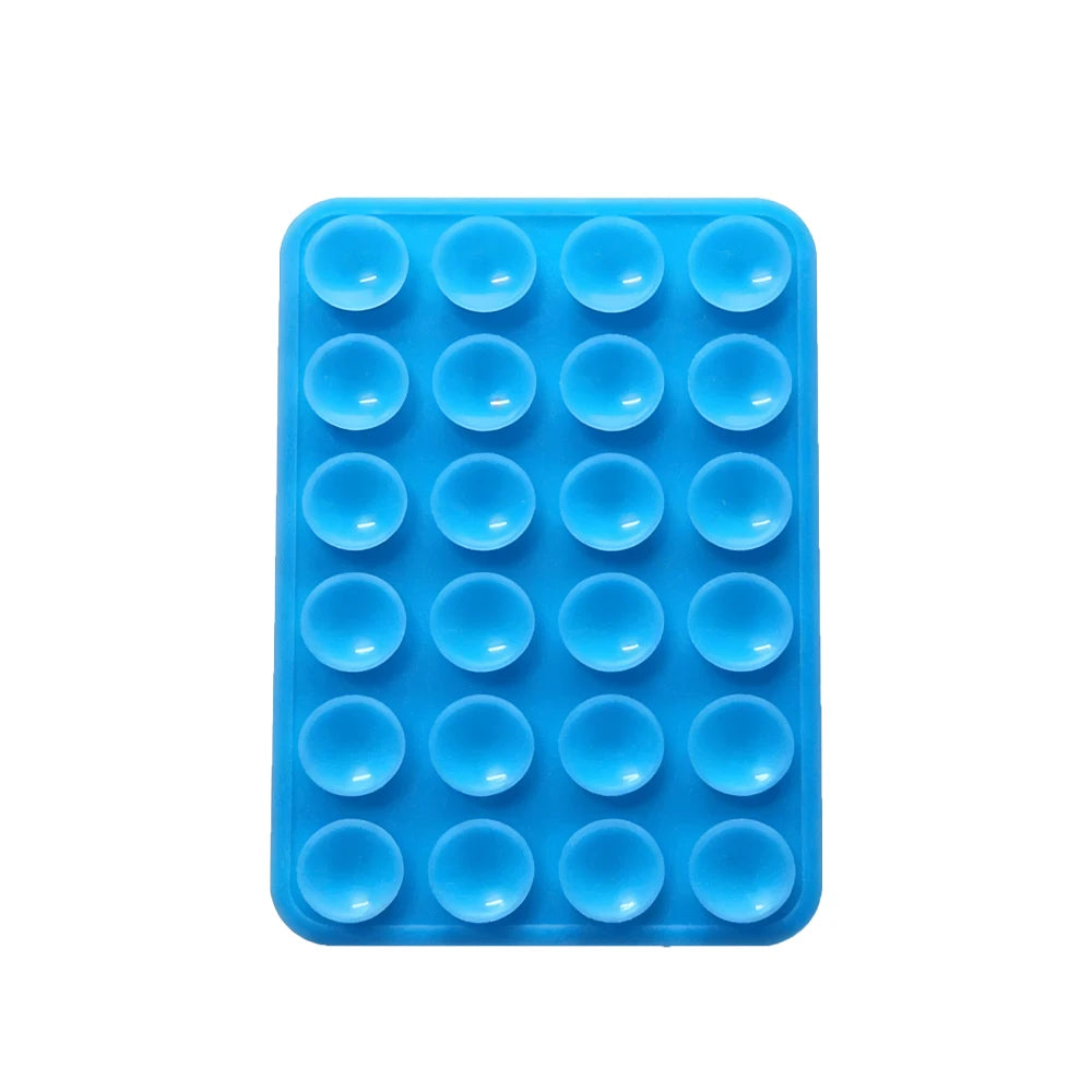A blue silicone suction pad with multiple circular indentations for phone mounts.