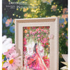 A wooden picture frame decorated with a floral vine pattern featuring pink and red roses and greenery.
