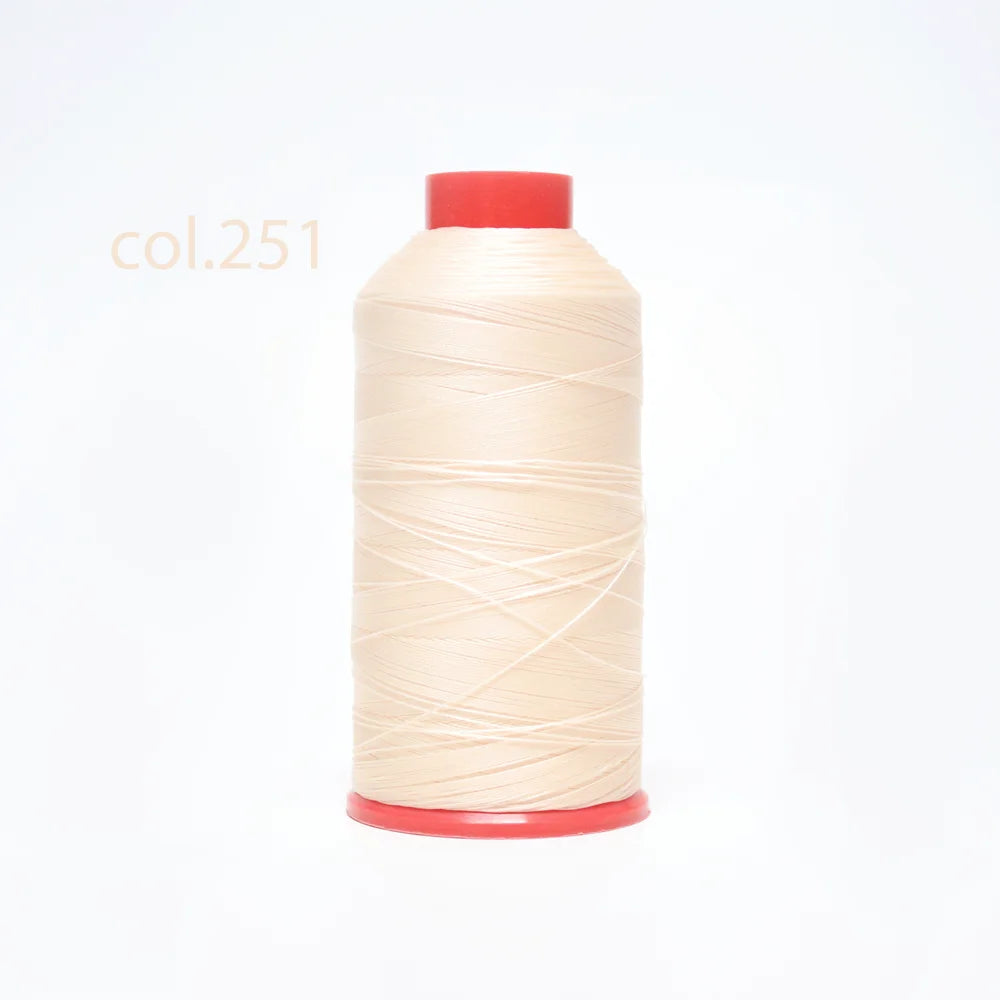 A spool of light beige heavy-duty nylon bonded thread with a red cap.