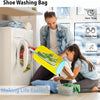 A person is using a yellow shoe washing bag and brush set to clean shoes inside a white washing machine.