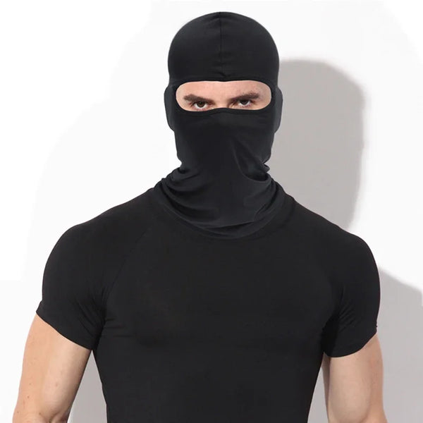 A man wearing a black windproof full face balaclava and black shirt.