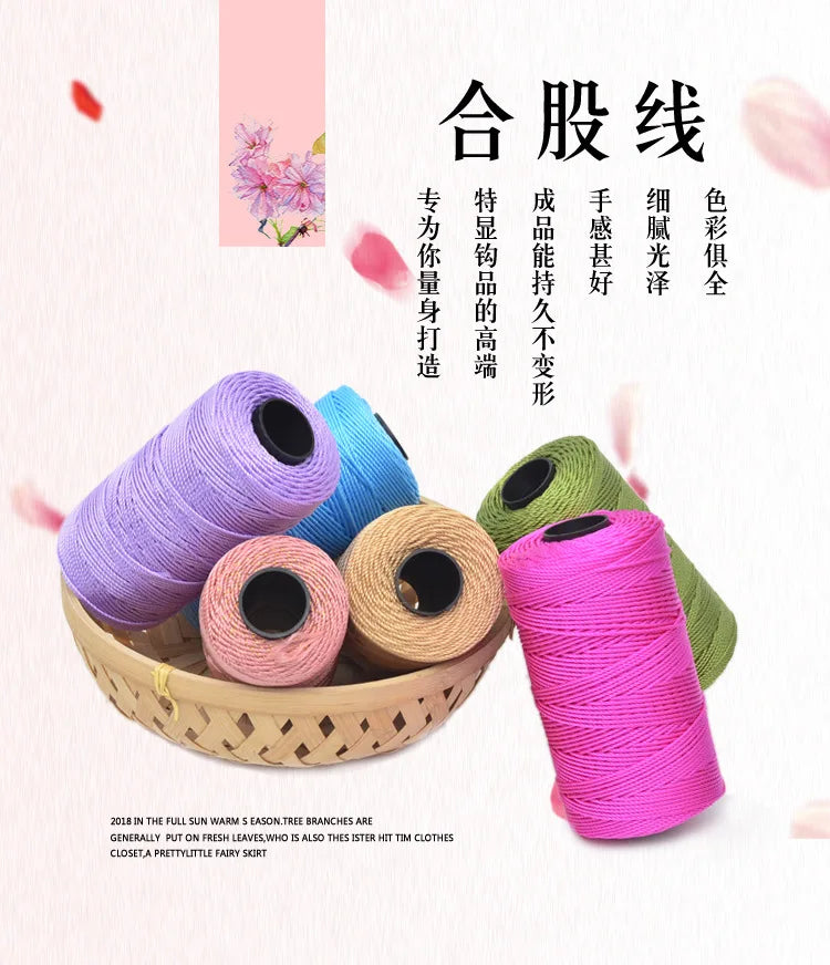 A collection of pink and green yarn spools for knitting and crochet crafts.