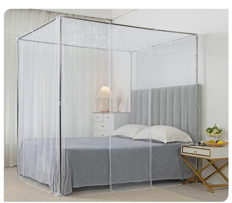 A princess-style lace canopy mosquito net draped over a bed, featuring sheer white fabric and gray bedding.