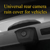 A black rain cover for a vehicle's rear camera is shown mounted on the car body.