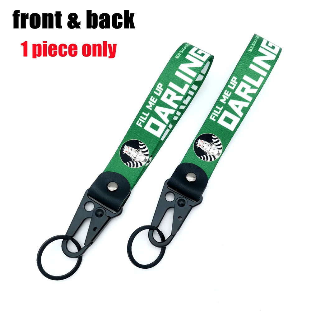 A single green fabric strap keychain with a silver clip and black and white tiger design.