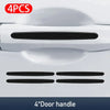 Four carbon fiber door handle protector stickers for car doors.