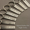 Engraved stainless steel keychains featuring messages like I love you and don't do stupid shit