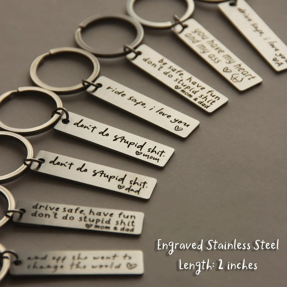 Engraved stainless steel keychains featuring messages like I love you and don't do stupid shit