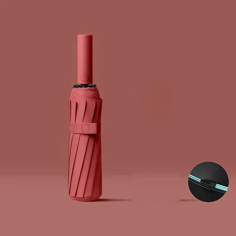 A pink automatic windproof travel umbrella with a black handle and UV protection feature.