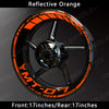 Reflective orange decals on a black motorcycle wheel rim for a Yamaha MT-07