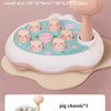 A small pig-themed pounding toy with multiple animal figures, including a hammer, shown on a light pink background.