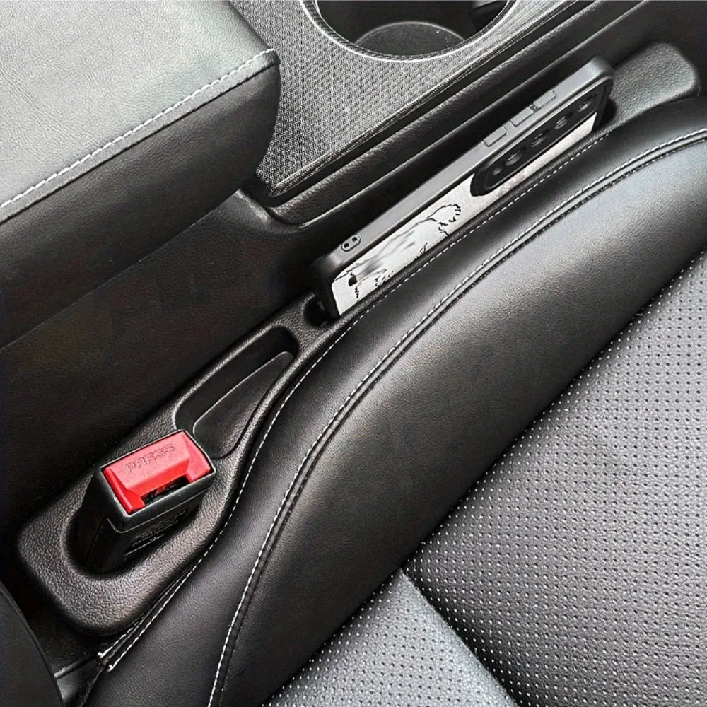 A close-up view of a car seat gap filler organizer with waterproof crevice storage placed in a vehicle console.