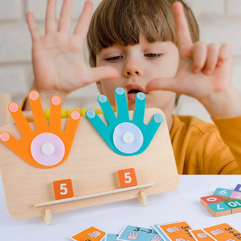A young child holds up a wooden counting toy with number blocks and activity cards for toddlers.