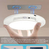 Hands demonstrate the easy installation of a white ceiling light using magnetic mounting methods.