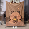 A tan flannel throw blanket featuring a cute cartoon bear face with a small yellow chick design.