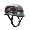 A silver half helmet with integrated brown goggles is shown for motorcycle and scooter riders.
