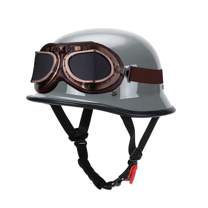 A silver half helmet with integrated brown goggles is shown for motorcycle and scooter riders.