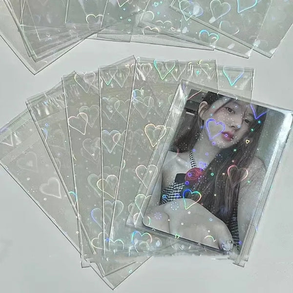 A stack of clear holographic card sleeves featuring a portrait of a person with dark hair and pink lipstick.